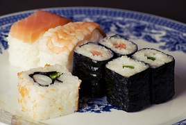 salmon, prawn, rice, seeweed sushi rolls on blue and white dish
